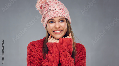 Close up face portrait of toothy smiling young woman wearing red sweater