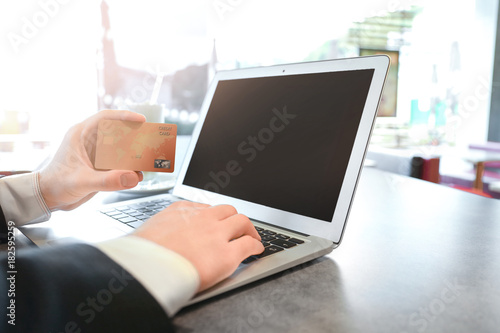 Young man using laptop and ...