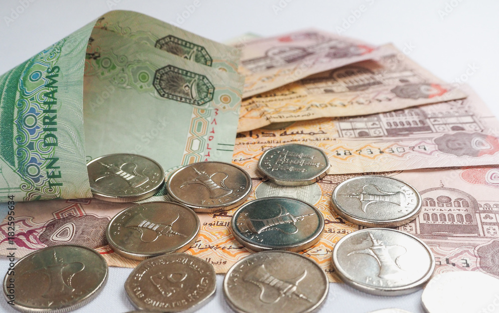 UAE dirham currency notes and coins. Stock Photo | Adobe Stock