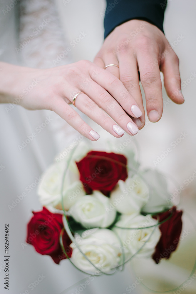 Bride and groom after ceremony showing wedding rings on their fingers. Bride and groom after ceremony showing wedding rings on their fingers.
