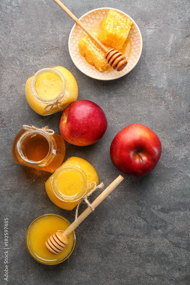 Composition with aromatic honey and fruit on gray table Composition with aromatic honey and fruit on gray table