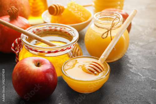 Composition with aromatic honey and fruit on gray table