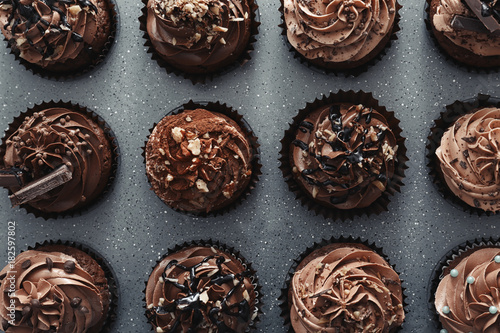 Muffin tin with tasty chocolate cupcakes, closeup