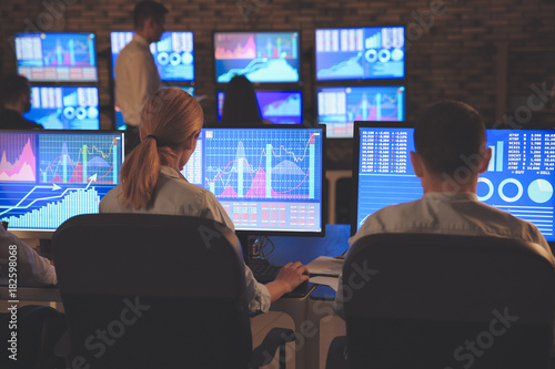 Stock traders working in of...