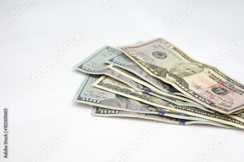 Pile of various US american dollar money bills spread on white background.