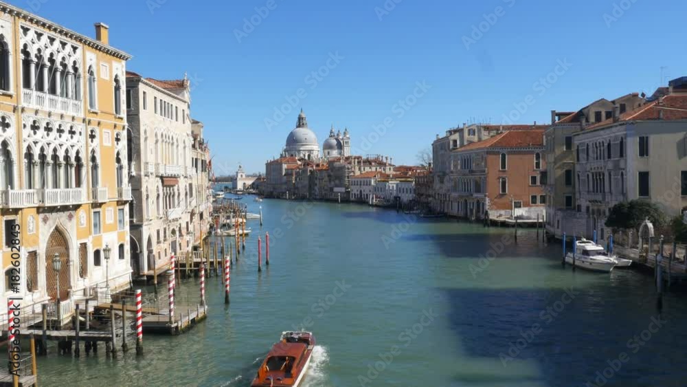 Pleasure boat sailing along Grand Canal in tourist downtown of Venice city, Italy. Pleasure boat sailing along Grand Canal in tourist downtown of Venice city, Italy.