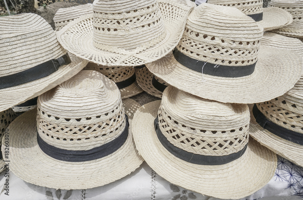 Handmade straw hats as a background