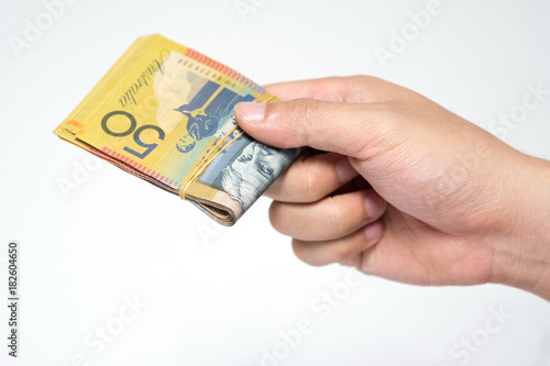 Close up fifty Australia Dollar money bills in hand isolated on white background.