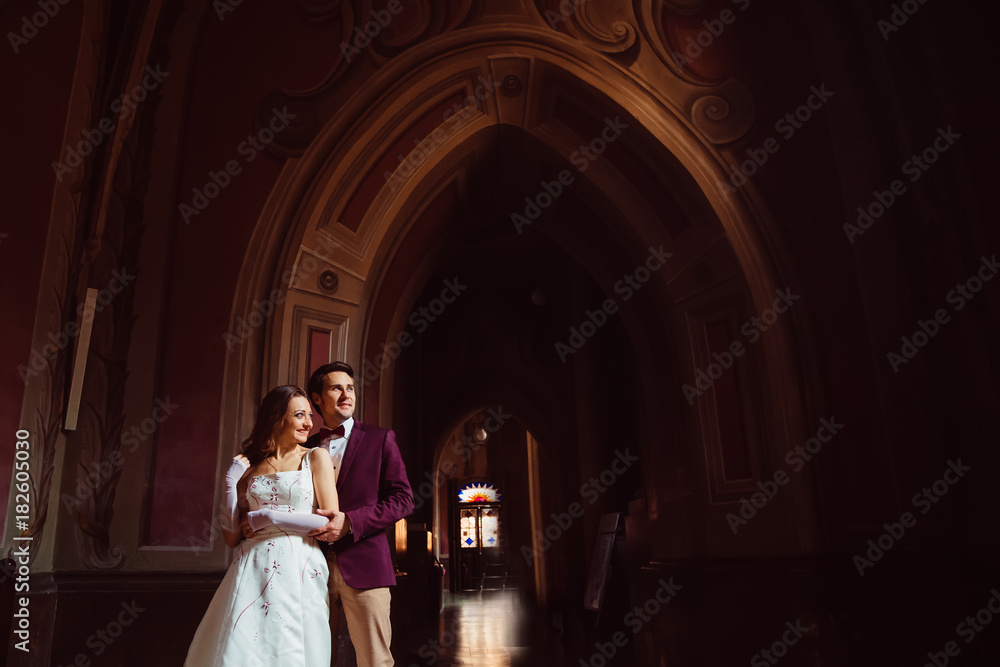 A young couple among the chic interior of the ancient palace A young couple among the chic interior of the ancient palace