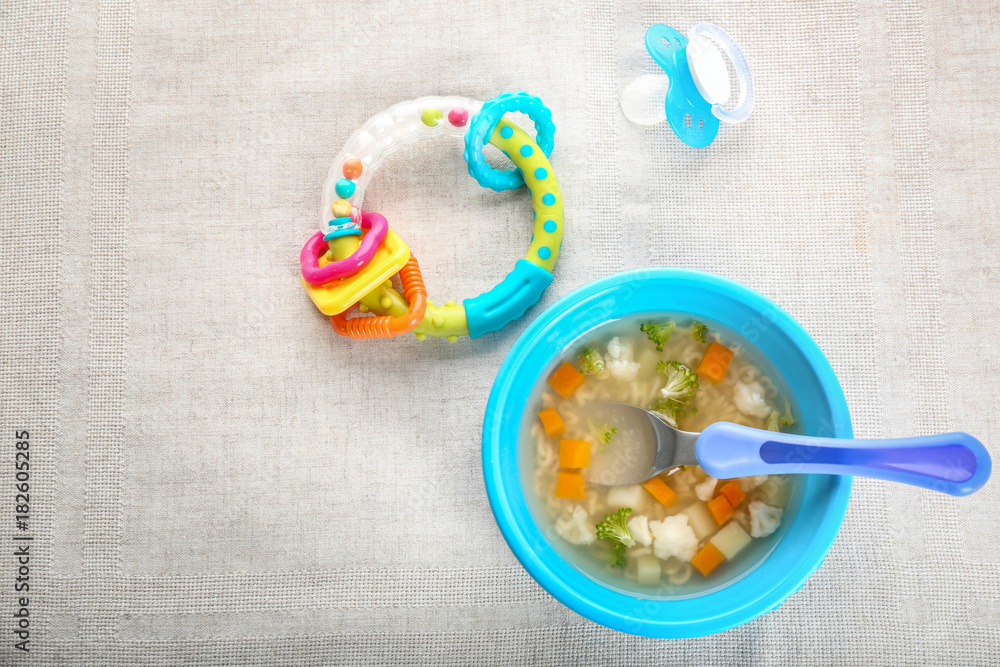 Plate with tasty baby soup on table Plate with tasty baby soup on table