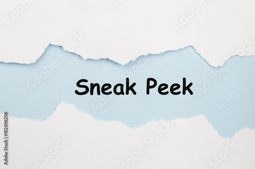 The phrase Sneak Peek appearing behind torn paper. photo