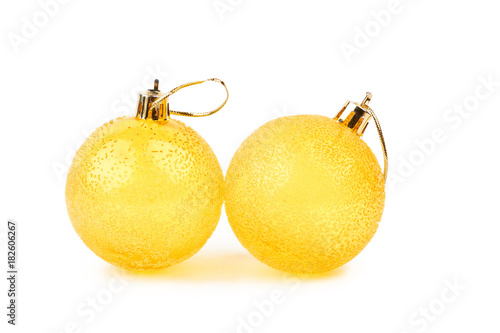 Two textured yellow Christmas balls. Couple of beautiful round Christmas toys isolated on white background. Traditional Christmas ornaments.