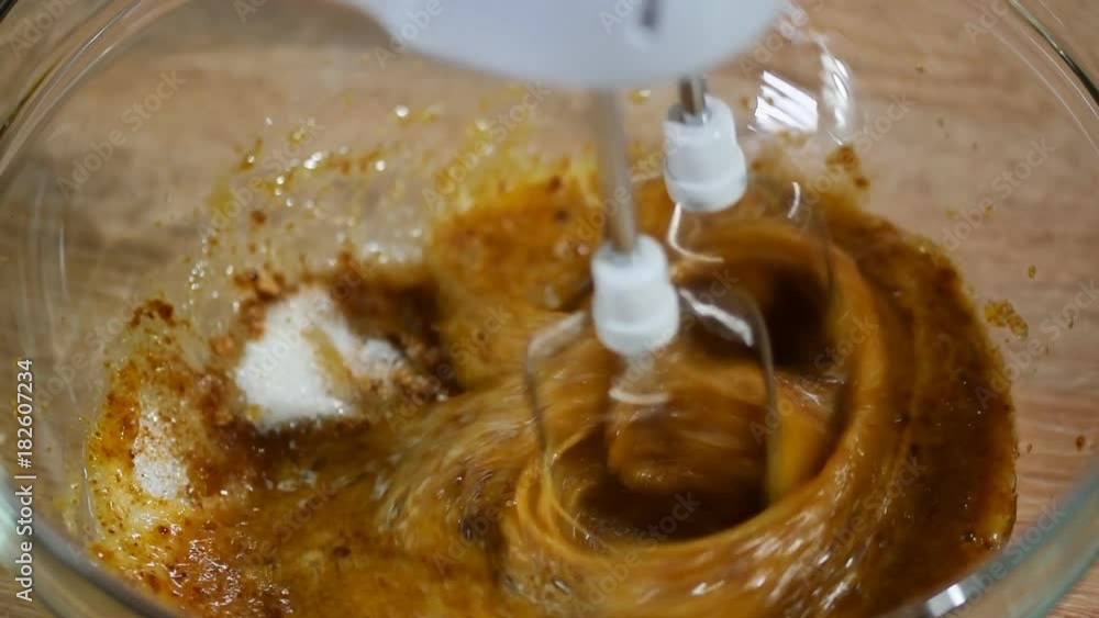 Eggs and brown sugar in bowl beat with a mixer Eggs and brown sugar in bowl beat with a mixer