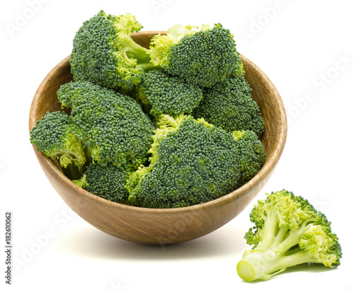 Fresh broccoli in a wooden bowl isolated on white background.