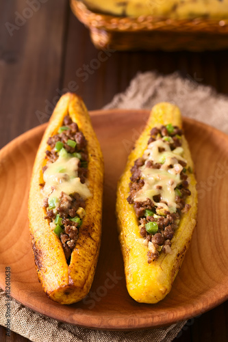 Baked ripe plantain stuffed with mincemeat, olive, capsicum, onion, traditional dish in Central America called Canoa de Platano (Plantain Canoe) (Selective Focus one third into the image)