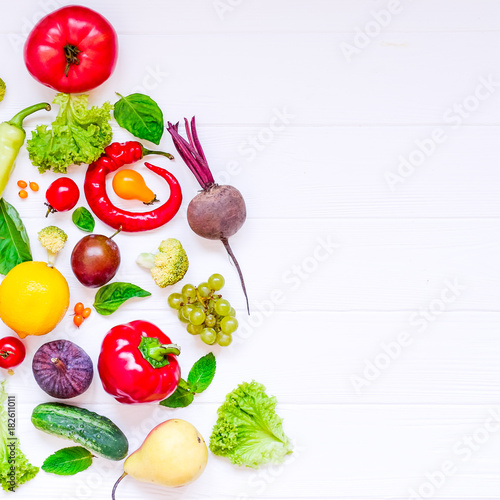 Healthy new year concept - fresh organic vegetables, herbs and fruits in the form of part of x-mas tree on white wooden background. Diet, detox planning. Top view. Selective focus. space for text.