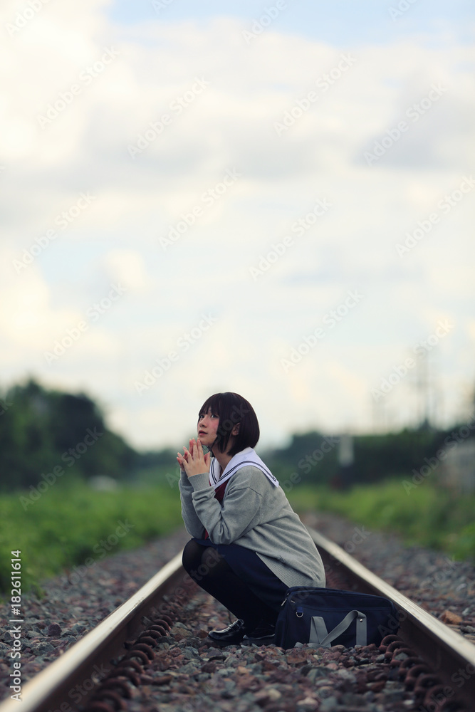 Fototapeta premium Portrait of Japanese school girl with countryside park