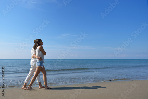 Beach couple walking on romantic travel honeymoon vacation summer holidays romance.