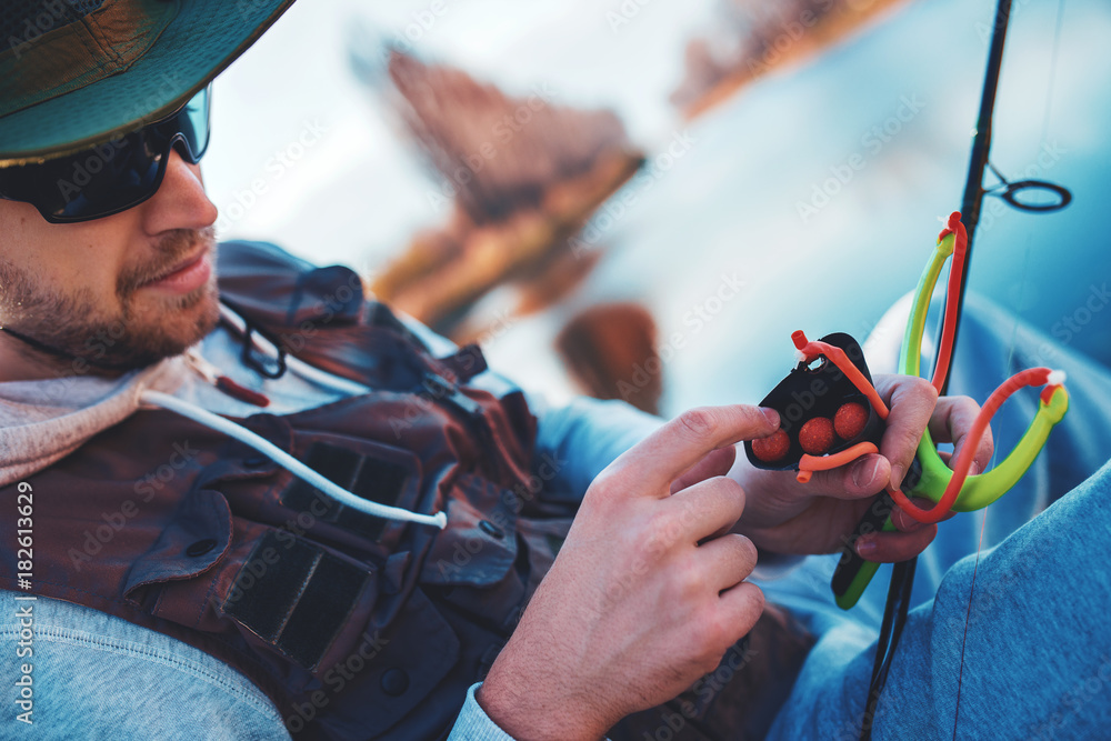 Angler enjoys in fishing on the river. Sport, recreation, lifestyle Angler enjoys in fishing on the river. Sport, recreation, lifestyle