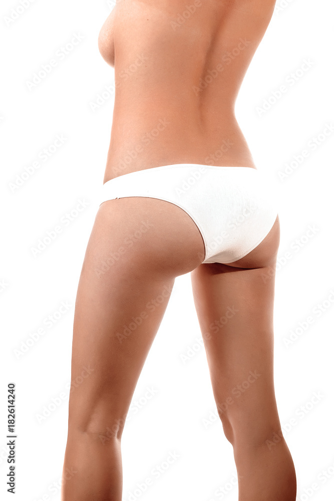 Perfect female body, buttocks close-up in white underwear, isolated on white background. The concept of beauty, plastic surgery.