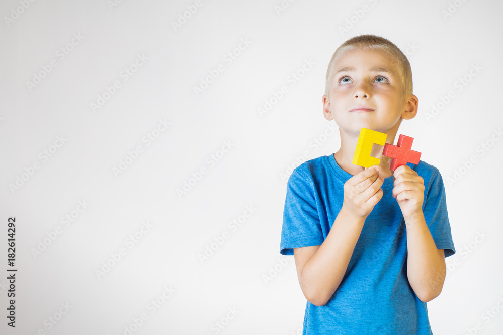 Boy with wooden logical toy. Child playing educational toys. Boy with wooden logical toy. Child playing educational toys.