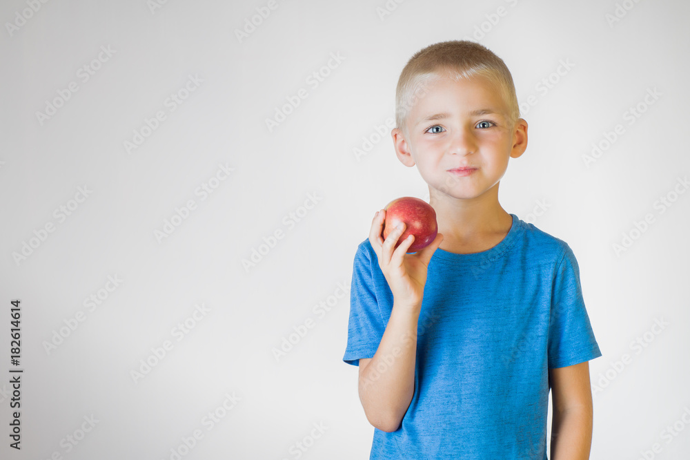 Closeup portrait happy, smiling boy, lifting red apple and dumbbell. Closeup portrait happy, smiling boy, lifting red apple and dumbbell.