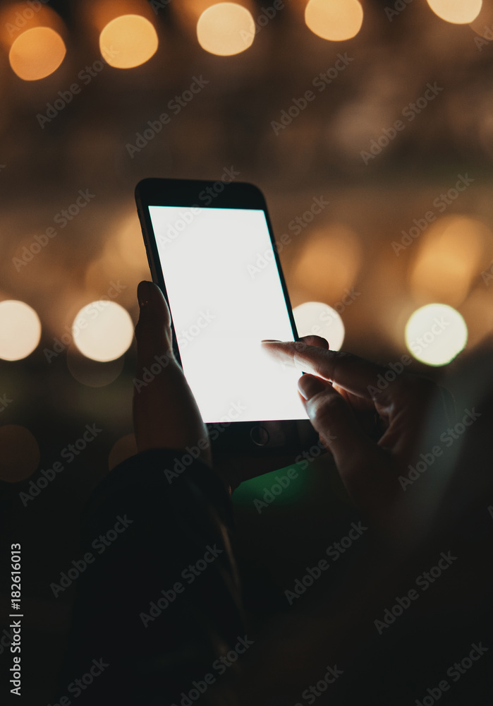 Closeup view of woman holding modern smartphone in hands. Girl pointing fingers on blank copy space screen for your text message or advertising content. Horizontal, blurred background, bokeh effects. Closeup view of woman holding modern smartphone in hands. Girl pointing fingers on blank copy space screen for your text message or advertising content. Horizontal, blurred background, bokeh effects.