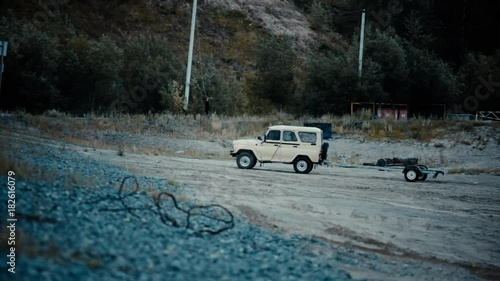 the fishing car is on the sand on the wild shore