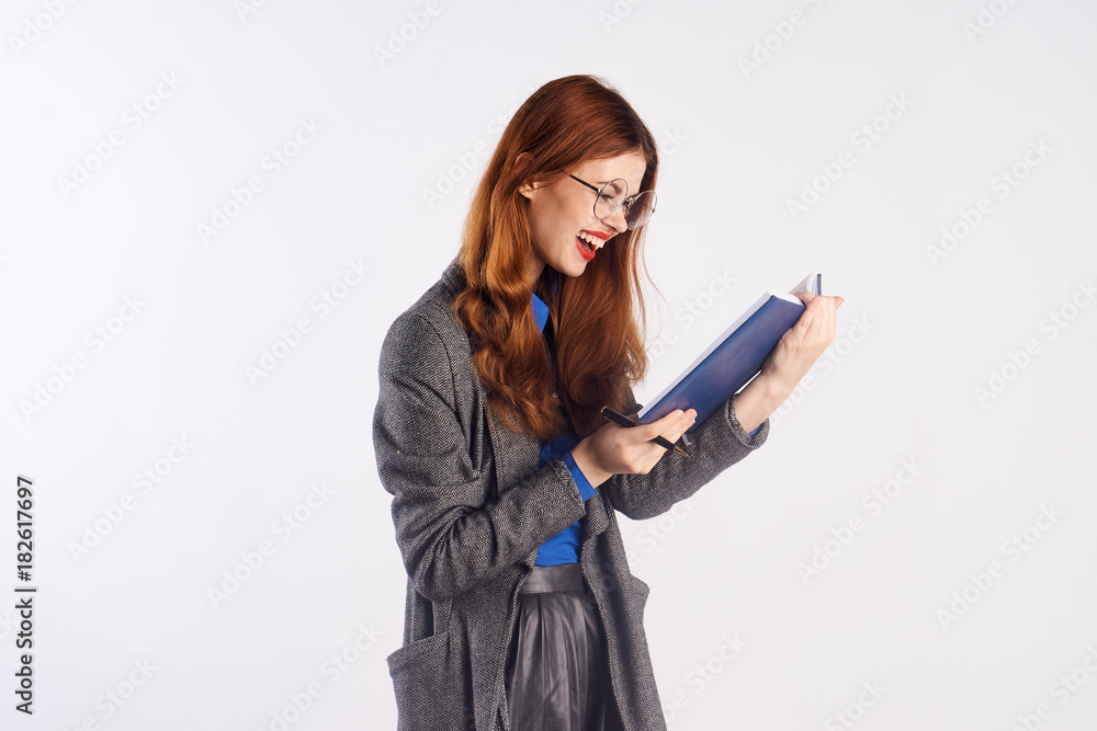 beautiful red-haired girl examines report and laughs beautiful red-haired girl examines report and laughs