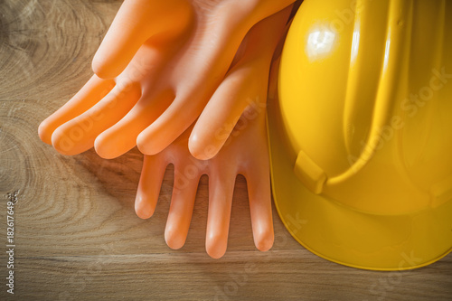 Safety building helmet electricians gloves on wood board