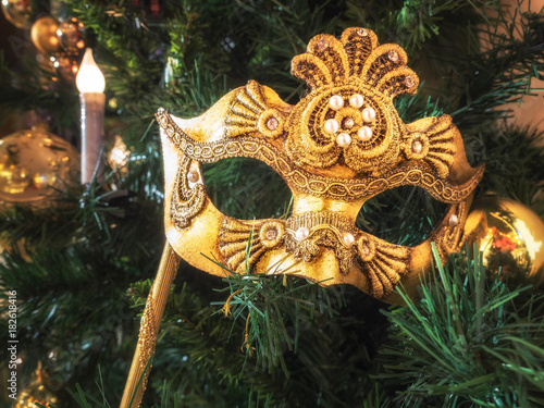 Venetian carnival mask on christmas tree. Christmas and New Year's background. Christmas tree, ball, candle, mask, Christmas decorations