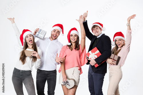 Portrait happy people group with a presents isolated on white background.