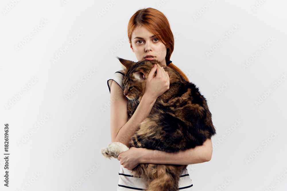 red-haired girl holding a large fluffy cat