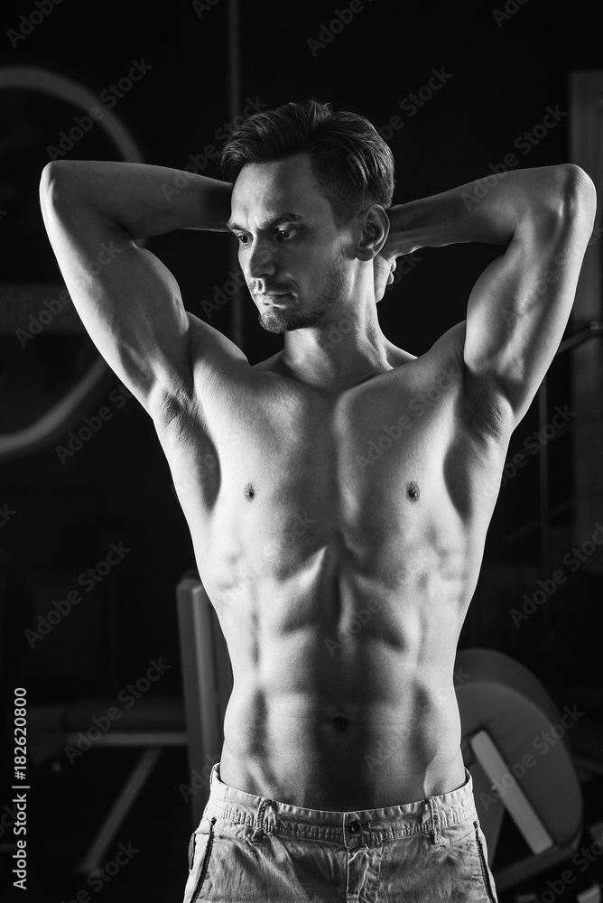 Fototapeta premium Strong Muscular man with naked torso abs . Black and white photo.
