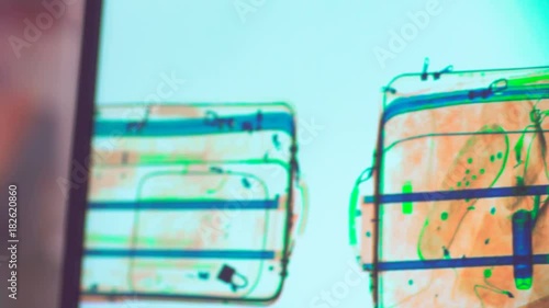 items scanned in the x-ray machine at an airport security checkpoint station.