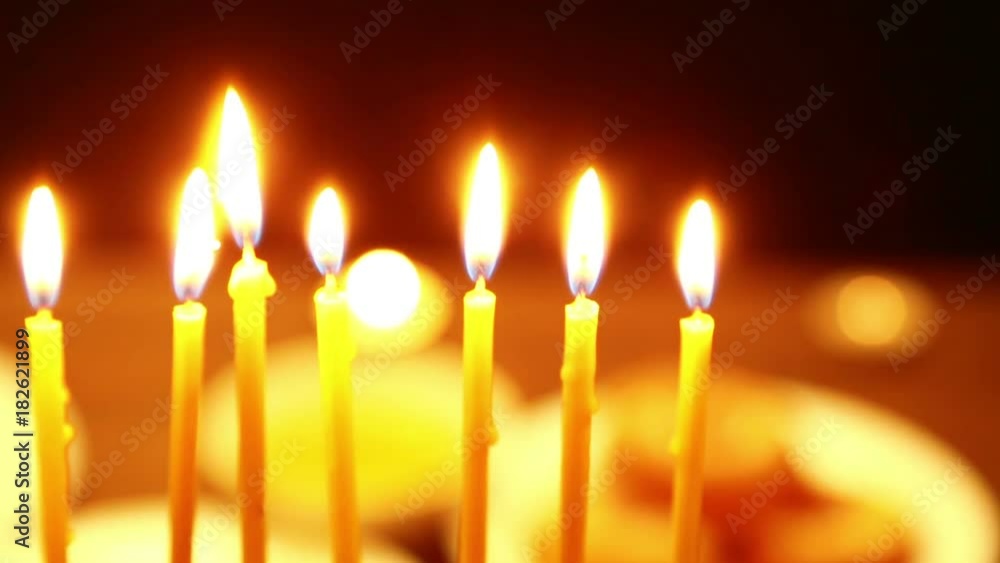 on the table is a candlestick for the Hanukkah in which there are burning candles. the camera moves from left to right. on the table is a candlestick for the Hanukkah in which there are burning candles. the camera moves from left to right.