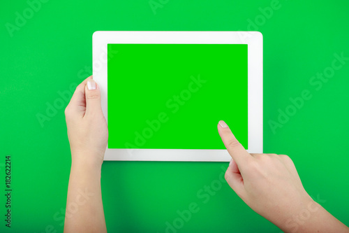 Digital Tablet and Hands on green Background
