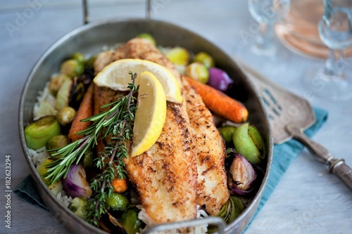 fried fish with rice and vegetables