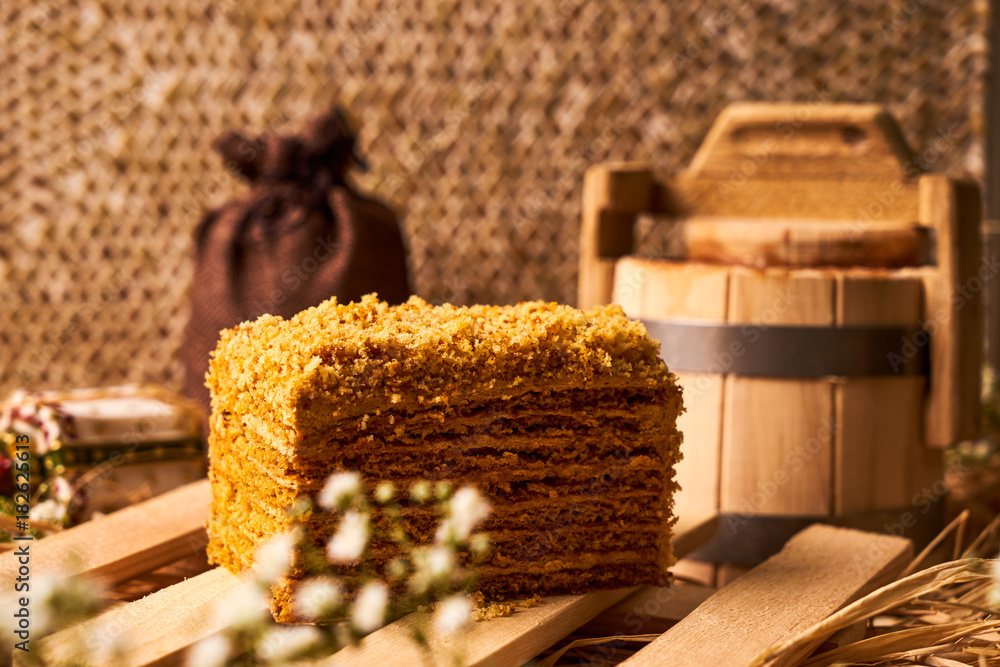 Slice of layered honey cake with sour cream Slice of layered honey cake with sour cream
