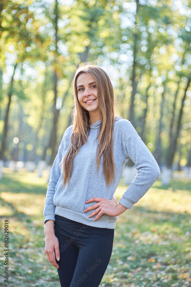 Sporty girl resting in the Park. Morning in the Park