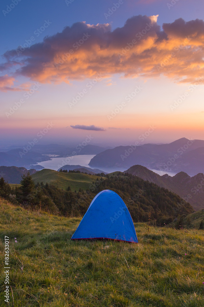 Camping outdoor with a tent with lake Iseo and Montisola at dusk, Brescia province, Lombardy district, Italy