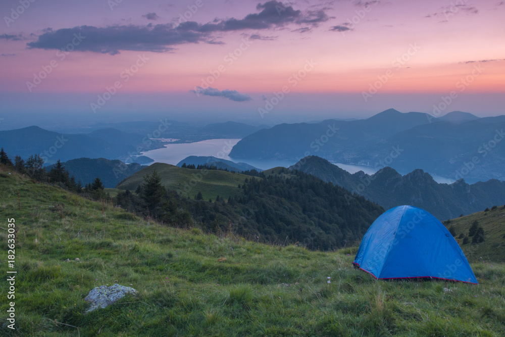 Camping outdoor with a tent with lake Iseo and Montisola at dusk, Brescia province, Lombardy district, Italy