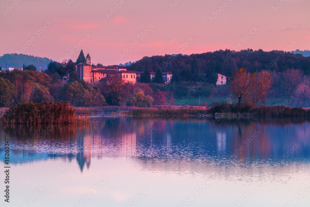 Sunset in Torbiere del Sebino with a castel reflected, Nature Reserve, Iseo, Brescia province, Lombardy district, Italy, Europe