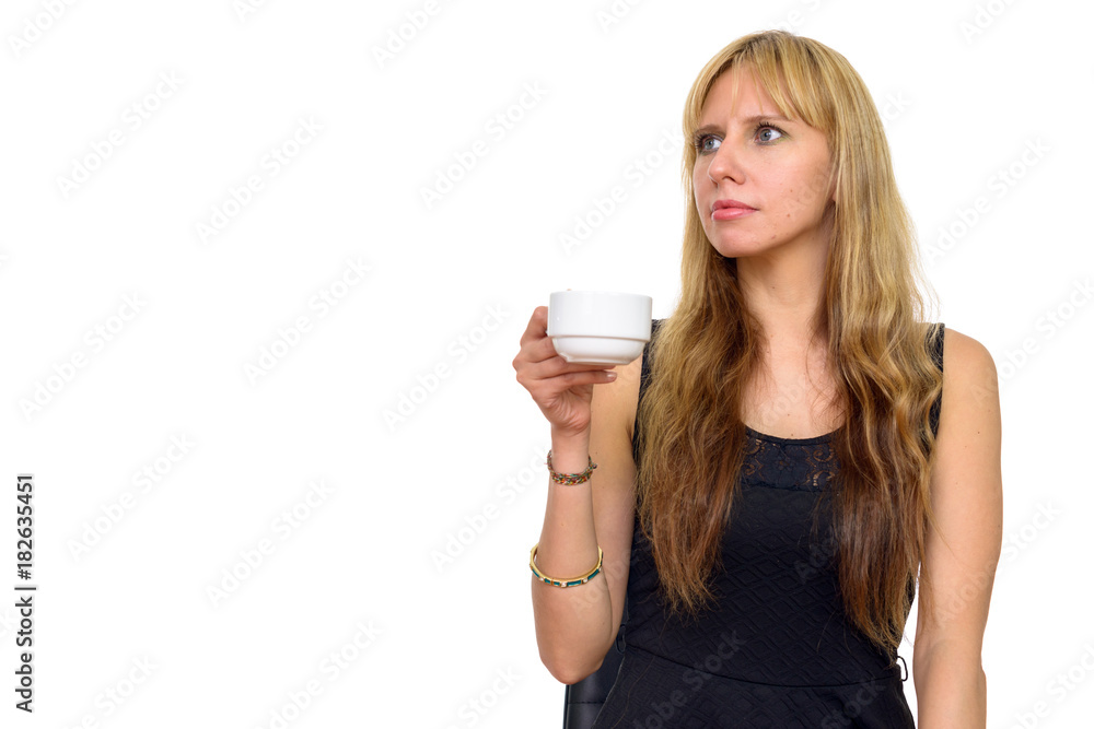 Studio shot of beautiful Caucasian woman holding coffee cup isolated against white background Studio shot of beautiful Caucasian woman holding coffee cup isolated against white background