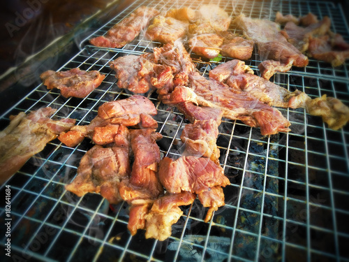 closeup of meat grilled on stove,celebration party in family with delicious barbecued ribs and beef seasoned with a spicy basting sauce,freshly grilled steaks and vegetables