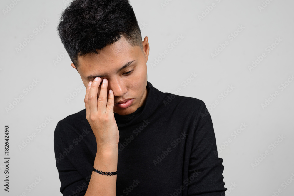 Portrait of Asian young tomboy looking sad and worried while thinking Portrait of Asian young tomboy looking sad and worried while thinking