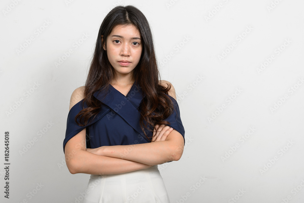 Fototapeta premium Portrait of young beautiful Asian woman against white background