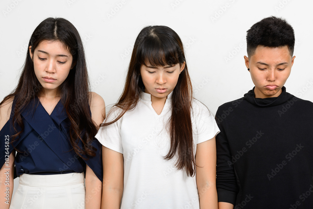 Group Of Three Young Asian Woman Indoors Against White Background Group Of Three Young Asian Woman Indoors Against White Background
