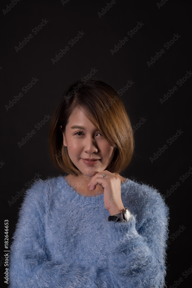 Portrait of beautiful asian woman wearing warm sweater in dark. Portrait of beautiful asian woman wearing warm sweater in dark.
