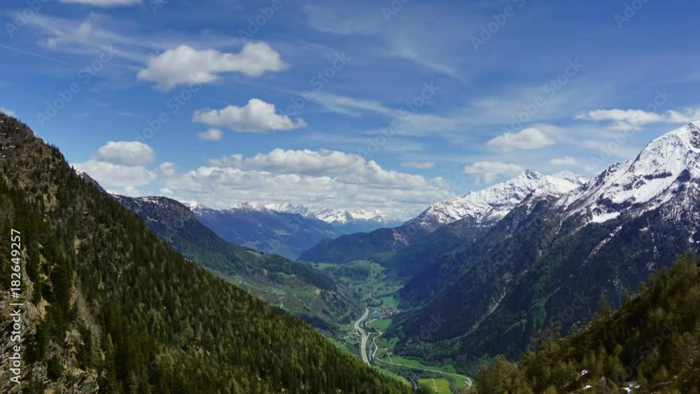 Beautiful top view of high snow-covered mountains and valley with road and village in Switzerland, zoom in timelapse
Beautiful top view of high snow-covered mountains and valley with road and village in Switzerland, zoom in timelapse